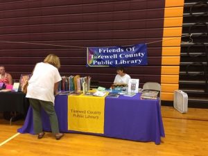 Image of the Friends of the library setting up a table at the 2019 Quilt Show in Bluefield, VA