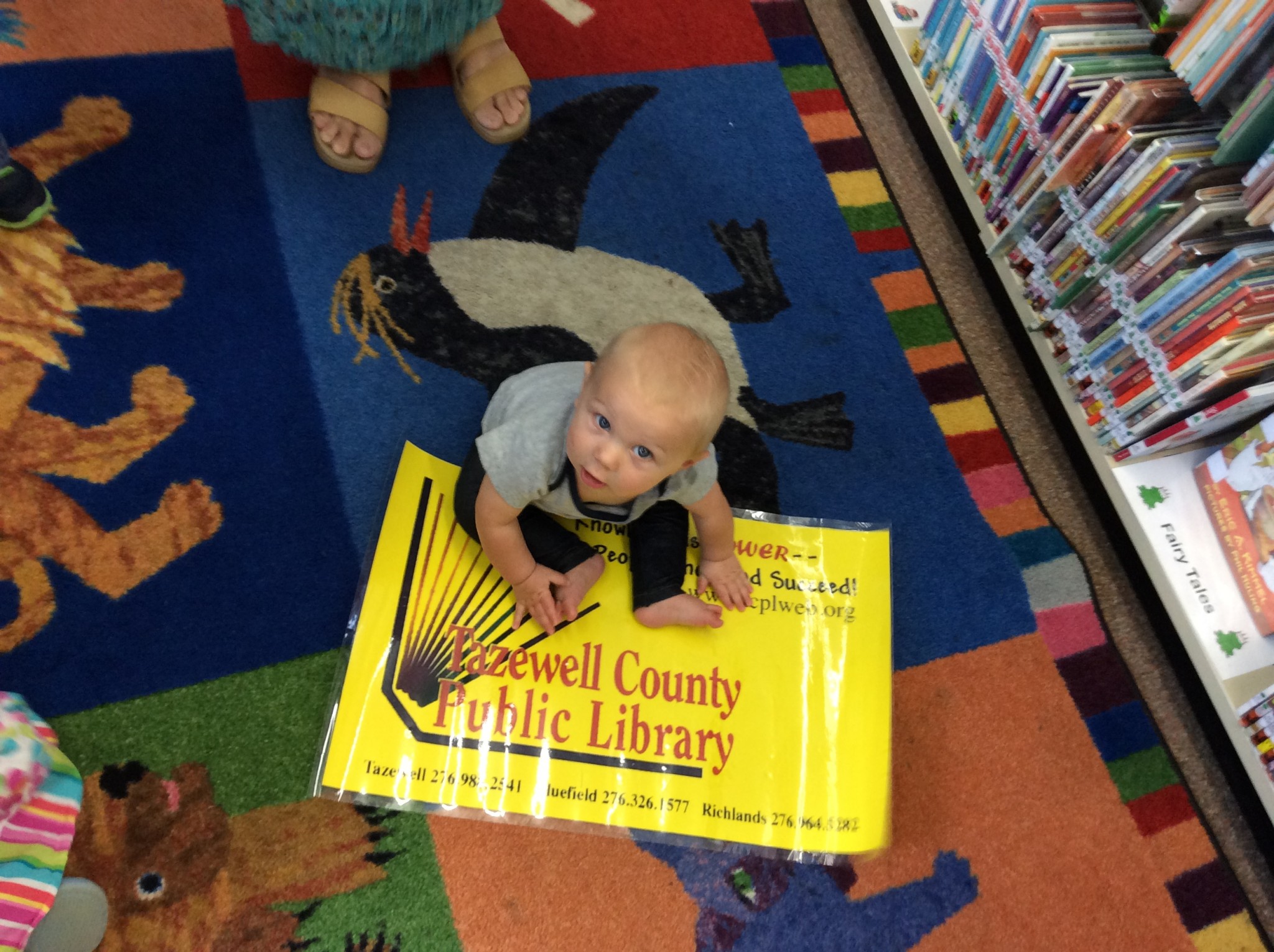 Decorative image of a baby with a large library card